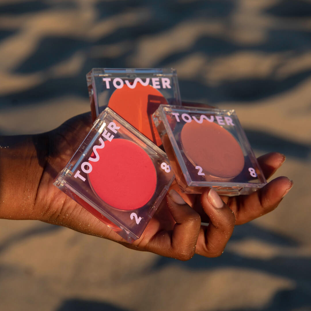 [Shared: Hand holding 3 Tower 28 BeachPlease Lip + Cheek Multitasker that creates a luminous finish, blends seamlessly, and has buildable color.]