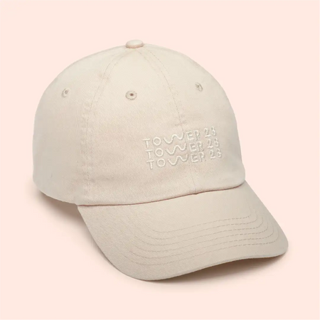 [Shared: Girl wearing Tower 28 Beauty Classic Baseball Cap Embroidered Baseball Hat with Adjustable Closure in Oatmeal Cream Color]